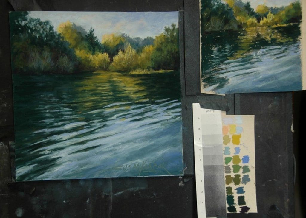 The finished painting on the easel with the colour study and colour swatch.